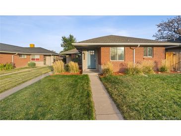 Brick ranch home with a landscaped yard and a blue front door at 3608 N Grape St, Denver, CO 80207