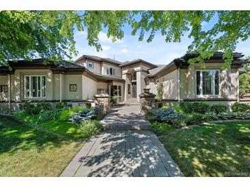 Two-story home with stone accents and landscaped yard at 5831 S Albion Ct, Greenwood Village, CO 80121