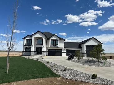Beautiful, modern two-story home with three-car garage and contemporary architectural features at 13350 Imboden Rd, Hudson, CO 80642