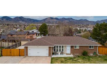 Charming brick home with mountain views, a two-car garage, and a cozy front patio at 4713 S Robb St, Littleton, CO 80127