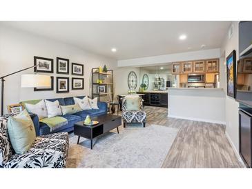 Bright living room features a comfy blue sofa and stylish coffee table at 9283 E Arbor Cir # B, Englewood, CO 80111