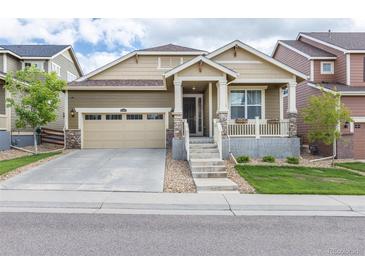 Charming single-Gathering home featuring a welcoming front porch and a well-maintained front yard at 22820 E Chenango Ave, Aurora, CO 80015