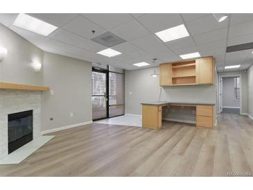 Bright office space with built-in desk and fireplace at 3872 S Dallas St # 7-101, Aurora, CO 80014