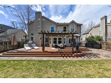 Enjoy the large backyard with a spacious deck, pergola, lounge area, and built-in fire pit at 270 S Locust St, Denver, CO 80224