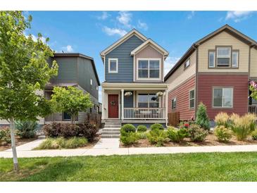 Charming two-story home with a cozy front porch and well-maintained landscaping at 12740 Tamarac St, Thornton, CO 80602