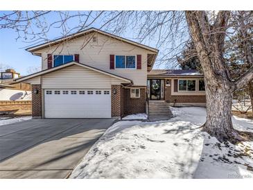 Charming two-story home featuring a spacious two-car garage and traditional brick accents at 2290 S Braun Way, Lakewood, CO 80228