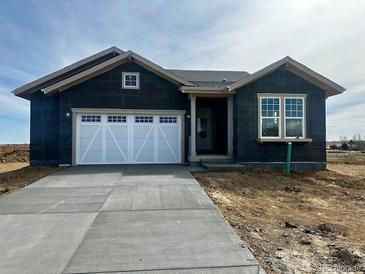 Charming single-story home featuring a two-car garage and a bright window, set in a construction phase at 6384 E 154Th Pl, Thornton, CO 80602