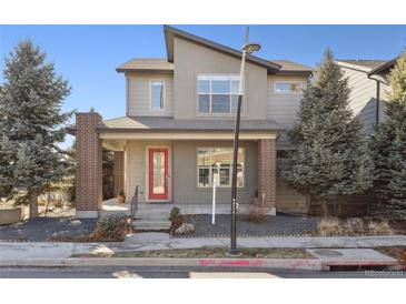 Charming two-story home with modern architecture, red front door, and landscaped front yard at 1622 W 67Th Ave, Denver, CO 80221