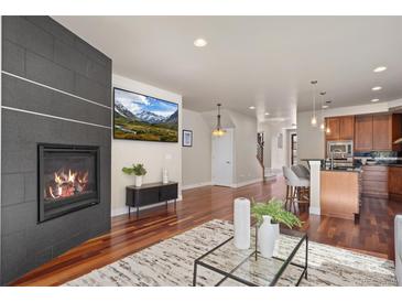 Inviting living room with fireplace, hardwood floors, and open floor plan at 2053 Meade St, Denver, CO 80211