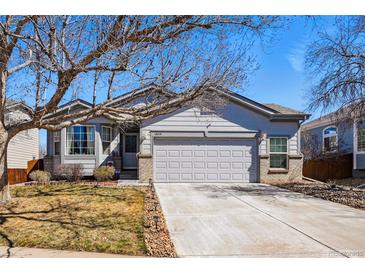 Charming single-Gathering home with a well-manicured lawn, mature trees, and a two-car garage and a neutral color scheme at 18315 E Amherst Dr, Aurora, CO 80013