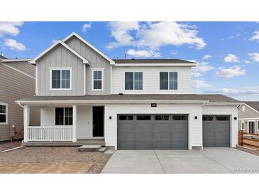 Charming two-story home featuring a three-car garage and covered porch at 39152 Clymer St, Elizabeth, CO 80107