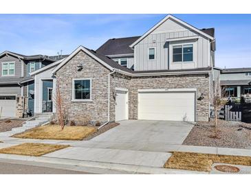 Charming two-story home featuring a stone facade, two-car garage and inviting curb appeal at 6400 Barnstead Dr, Castle Pines, CO 80108