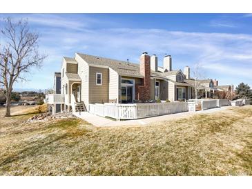 A home featuring a wooden deck, manicured lawn, and a view of the scenic surroundings at 162 Blue Spruce Ct, Highlands Ranch, CO 80126