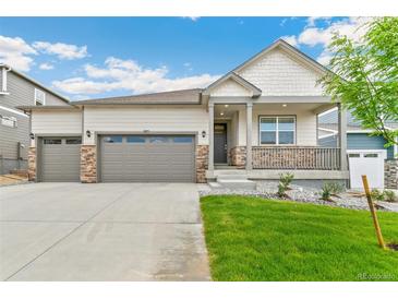Charming single-Gathering home featuring a welcoming front porch, gray siding, and an attached two-car garage at 4708 Windmill Dr, Brighton, CO 80601