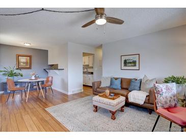 Comfortable living room with a decorative rug, leather couch, and a table and chairs in the background at 1105 Bacchus Dr # F8, Lafayette, CO 80026