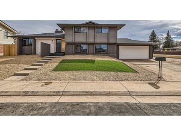 Inviting two-story home with an attached garage and minimalist rock garden landscape at 12932 E Elgin Pl, Denver, CO 80239