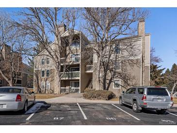 Attractive condo building with mature trees, parking, and balconies on a sunny day at 4896 S Dudley St # 5-5, Littleton, CO 80123