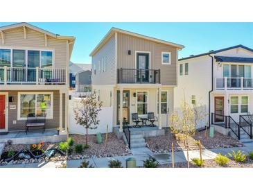 Charming two-story home featuring a balcony and a cozy front porch with seating area at 18284 E 49Th Pl, Denver, CO 80249