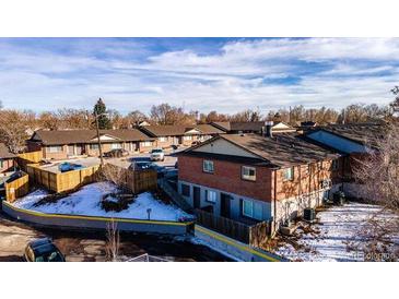 A charming townhome complex featuring brick exteriors and well-maintained landscaping at 4665 W 6Th Ave # 21, Denver, CO 80204