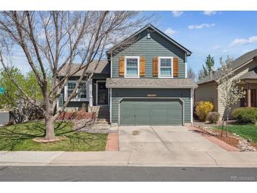 Charming two-story home with blue siding, wood shutters, and an attached two-car garage at 11072 Quail Ct, Parker, CO 80134