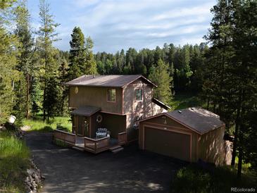 Charming exterior view of a two-story home with a deck and a detached garage at 10858 Norton Ave, Conifer, CO 80433