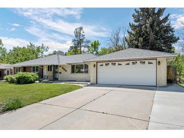 Charming single-story home features a well-maintained lawn, attached two-car garage, and welcoming curb appeal at 11328 W 27Th Ave, Lakewood, CO 80215