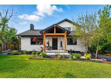 Charming two-story home with landscaped front yard and inviting covered porch with wooden beams at 1801 Redwood Ave, Boulder, CO 80304