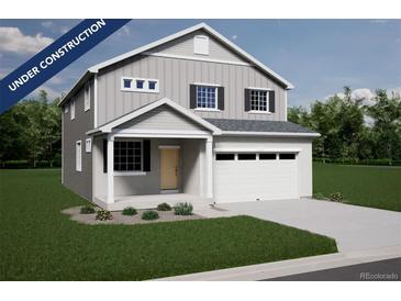 Charming two-story home with a welcoming porch and a two-car garage showcasing modern design and curb appeal at 3888 N Riviera Ct, Aurora, CO 80019