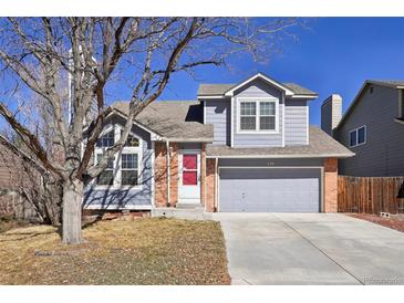 Charming two-story home featuring a well-maintained front yard and a gray painted facade and attached two-car garage at 176 S Pembrook St, Castle Rock, CO 80104