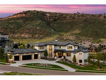 Stunning exterior elevation of a modern home, featuring a three-car garage and mountain views at 15191 Dinosaur Ridge Rd, Morrison, CO 80465