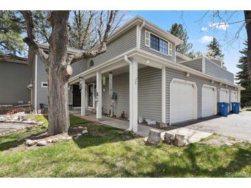 Charming home featuring a two-car garage, covered porch, and meticulously maintained lawn at 12622 E Warren Dr # E, Aurora, CO 80014