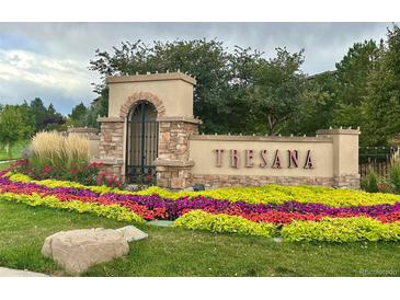 Beautiful community entrance sign with colorful flower beds and manicured landscaping at 9450 Sori Ln, Highlands Ranch, CO 80126