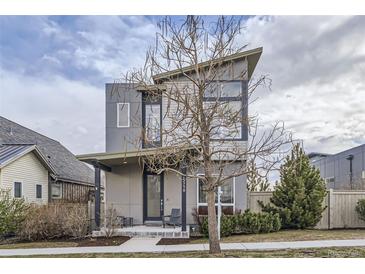 Contemporary home with modern architectural details and a welcoming front porch and neutral toned exterior at 1558 White Violet Way, Louisville, CO 80027