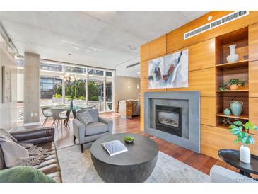 Bright living room features a fireplace, wood accents, and large windows for natural light at 1620 Little Raven St # 103, Denver, CO 80202