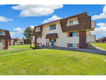 Charming apartment building featuring well-maintained landscaping and inviting facade under a blue sky at 10211 Ura Ln # 3-104, Thornton, CO 80260