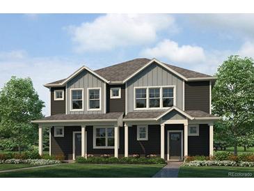 Beautiful townhome featuring black siding, gray accents, and a well-maintained lawn at 1372 S Boston Ct # A, Denver, CO 80247