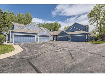 Charming multi-Gathering home featuring multiple garages with blue siding and a well-maintained front yard at 5016 S Nelson St # C, Littleton, CO 80127