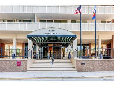 Embassy House entrance featuring flags and well-maintained stairs and awning at 1250 N Humboldt St # 202, Denver, CO 80218