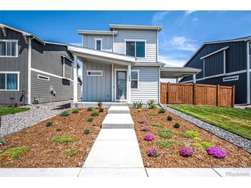 Charming two-story home with a modern design and beautifully landscaped front yard at 260 E 4Th St, Berthoud, CO 80513