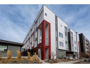 Modern townhouse featuring a striking white and grey facade with bold red accents and contemporary design at 2741 W 28Th Ave # 2, Denver, CO 80211