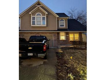 Charming two-story home with brick and siding, a two-car garage, and inviting curb appeal at 3839 E 135Th Way, Thornton, CO 80241