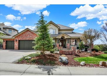 Beautiful two-story home with brick accents, mature landscaping, and attached two car garage at 9164 E Lost Hill Trl, Lone Tree, CO 80124