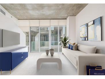 Bright living room featuring modern decor, large windows, and comfortable seating arrangement at 891 14Th St # 1506, Denver, CO 80202