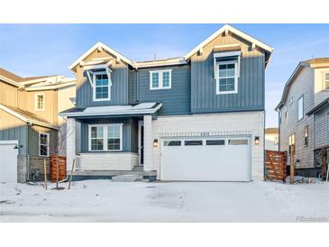 Two-story house with gray and white siding, a white door, and a two-car garage at 3372 N Buchanan Way, Aurora, CO 80019