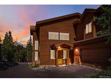 Charming exterior showcasing wood siding, a covered entry, and attached garage, perfect for mountain living at 180 Emmett Lode Rd, Breckenridge, CO 80424