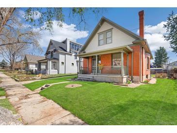 Charming brick home with a well-manicured lawn and inviting front porch at 2826 Quitman St, Denver, CO 80212
