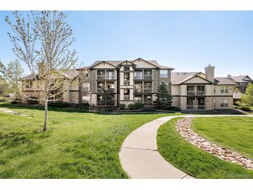 Attractive multi-story condo building with well-maintained landscaping and inviting walkway at 7423 S Quail Cir # 1533, Littleton, CO 80127