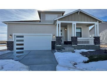 Two-story craftsman style home with covered porch and attached garage at 42976 Colonial Trl, Elizabeth, CO 80107