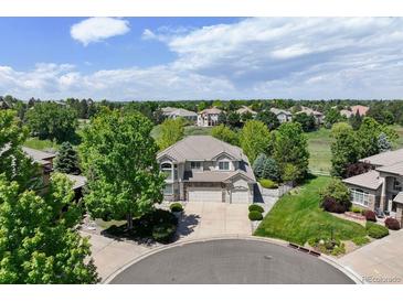 Inviting two-story home with a three-car garage and beautiful landscaping at 9278 E Aspen Hill Pl, Lone Tree, CO 80124