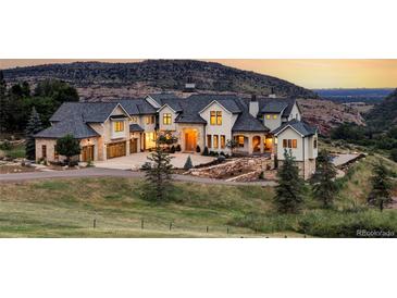 Luxury home with mountain views, expansive driveway, and landscaped grounds at 9356 Cherrywood Trl, Littleton, CO 80127